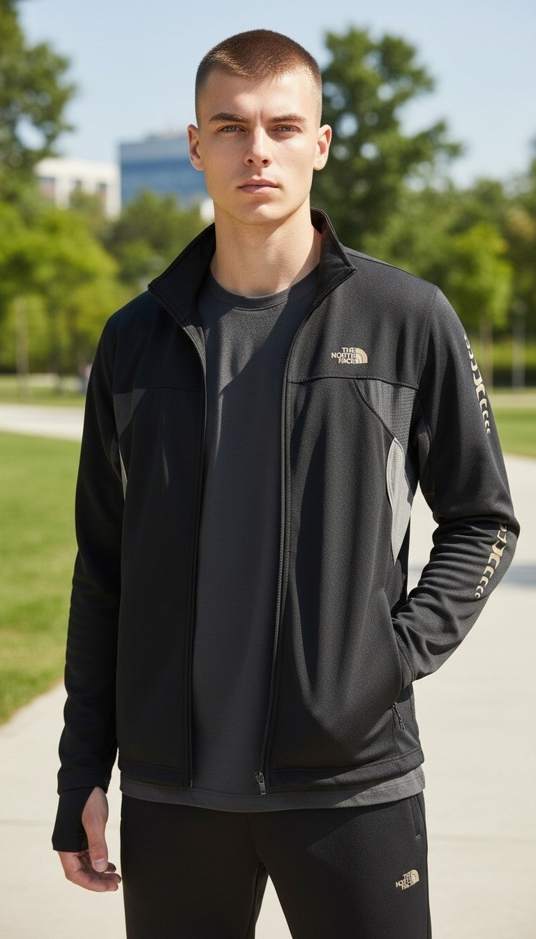 Off The Rails IOM men's black and grey The North Face running jacket with mock neck and thumbholes worn by a model